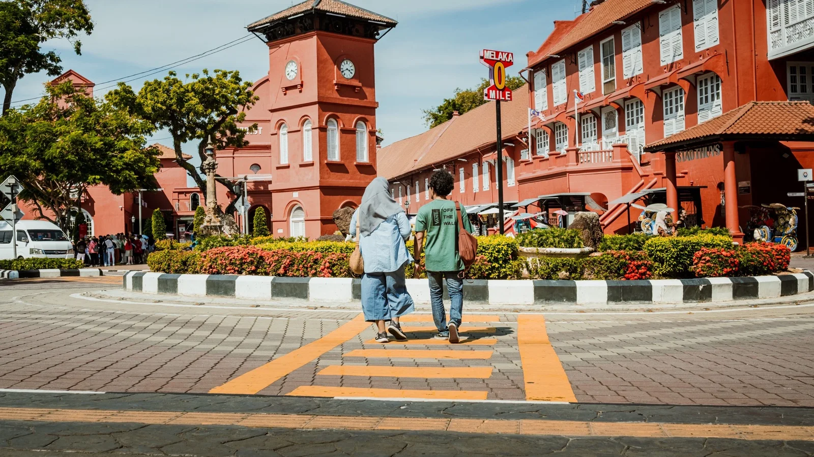 Terracotta-red Stadthuys and Christ Church framing Dutch Square in Malacca's old town in soft morning light
