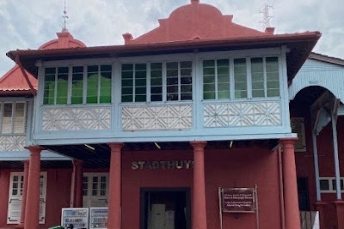 Terracotta-red Stadthuys and fountain at Dutch Square in Malacca's old town