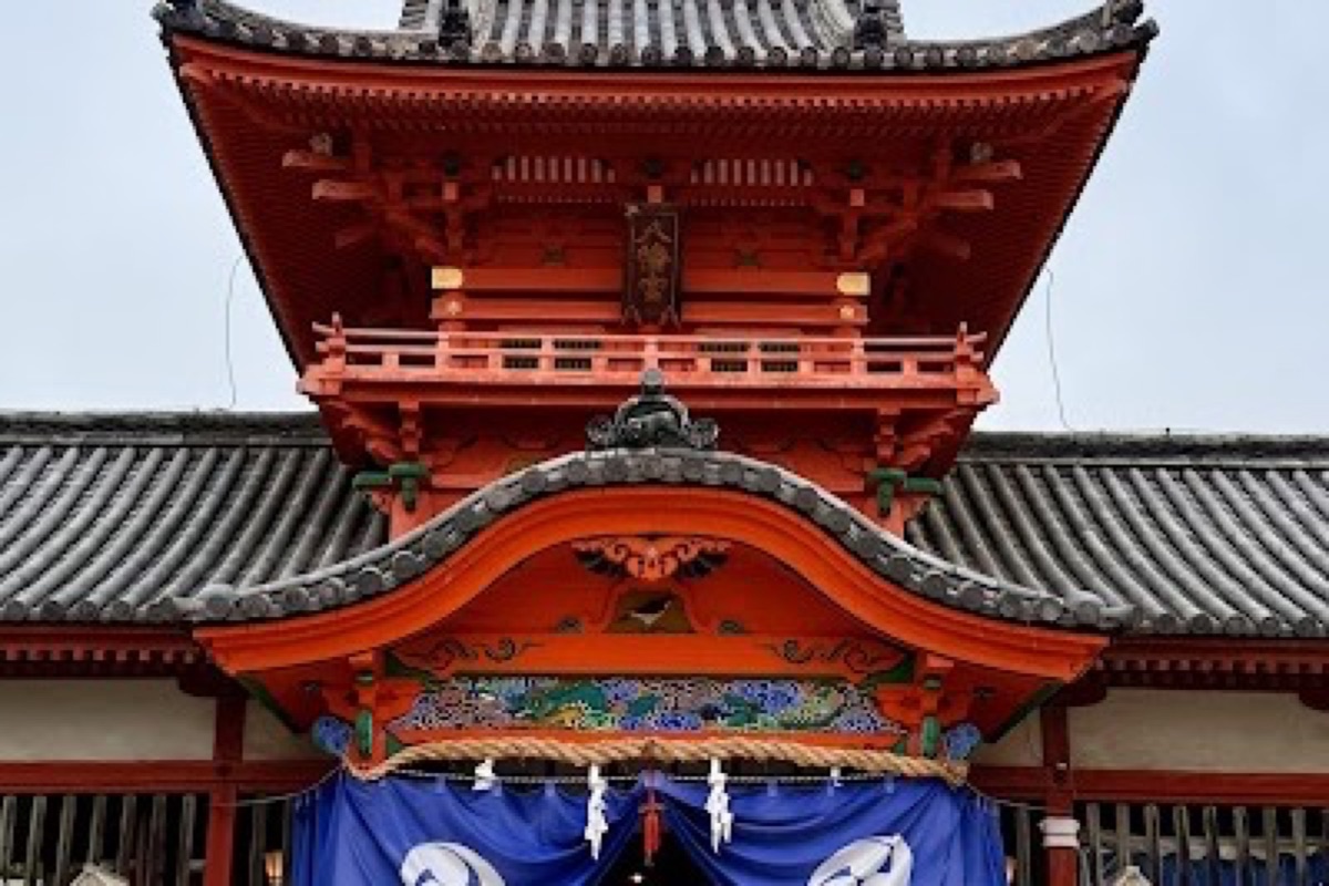 Isaniwa Shrine red torii gate and vermillion buildings in Matsuyama