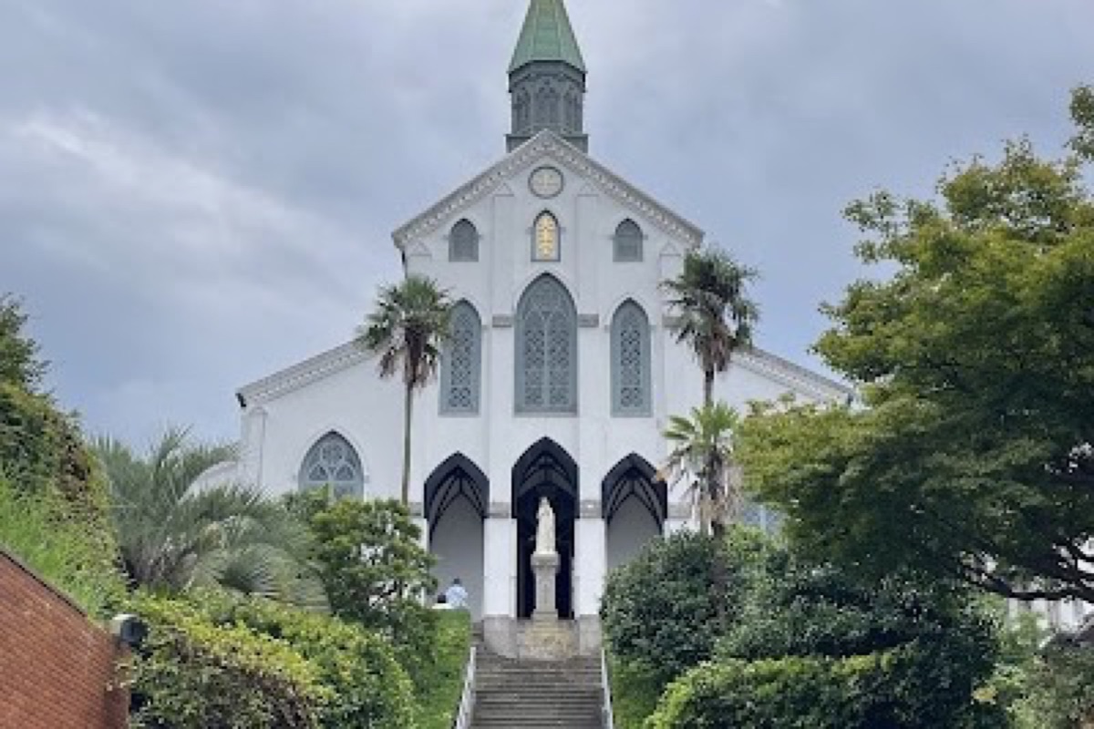 Oura Cathedral's Gothic stone facade set against the hillside in Nagasaki