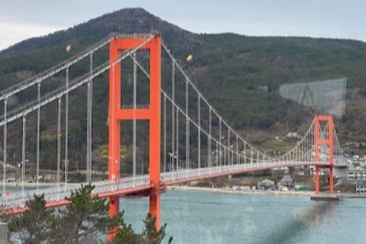 Namhae Bridge red suspension span from the mainland crossing viewpoint at sunrise