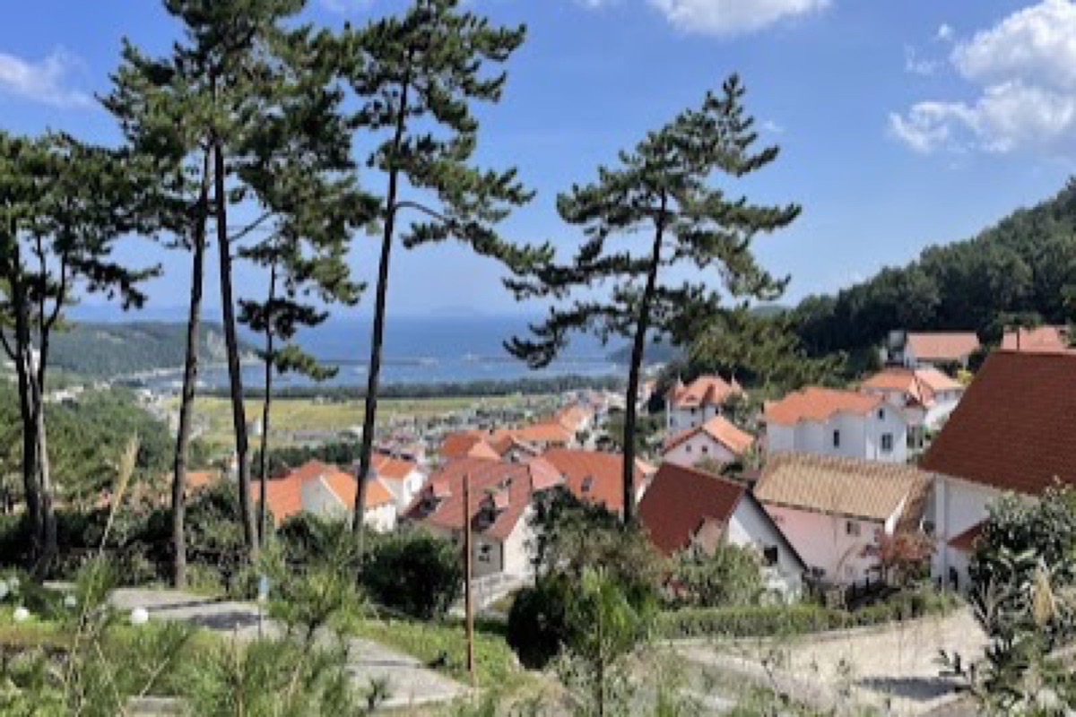 Namhae German Village pastel hillside homes with coastal panoramas and ocean views