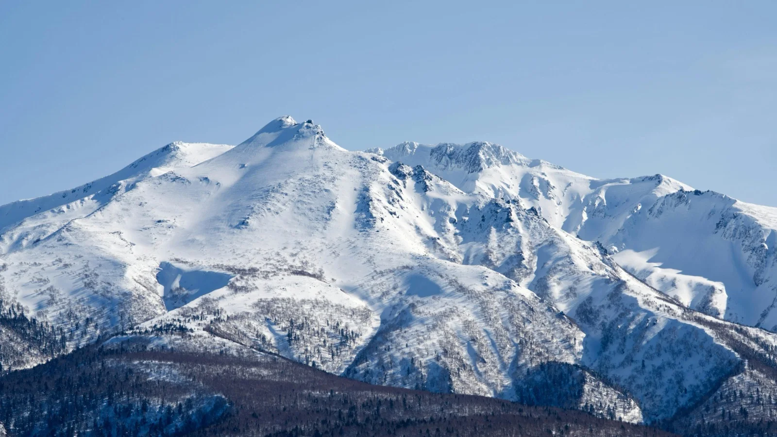 Snow-covered slopes of Grand Hirafu with Mt. Yotei in the background, Niseko, Hokkaido, Japan