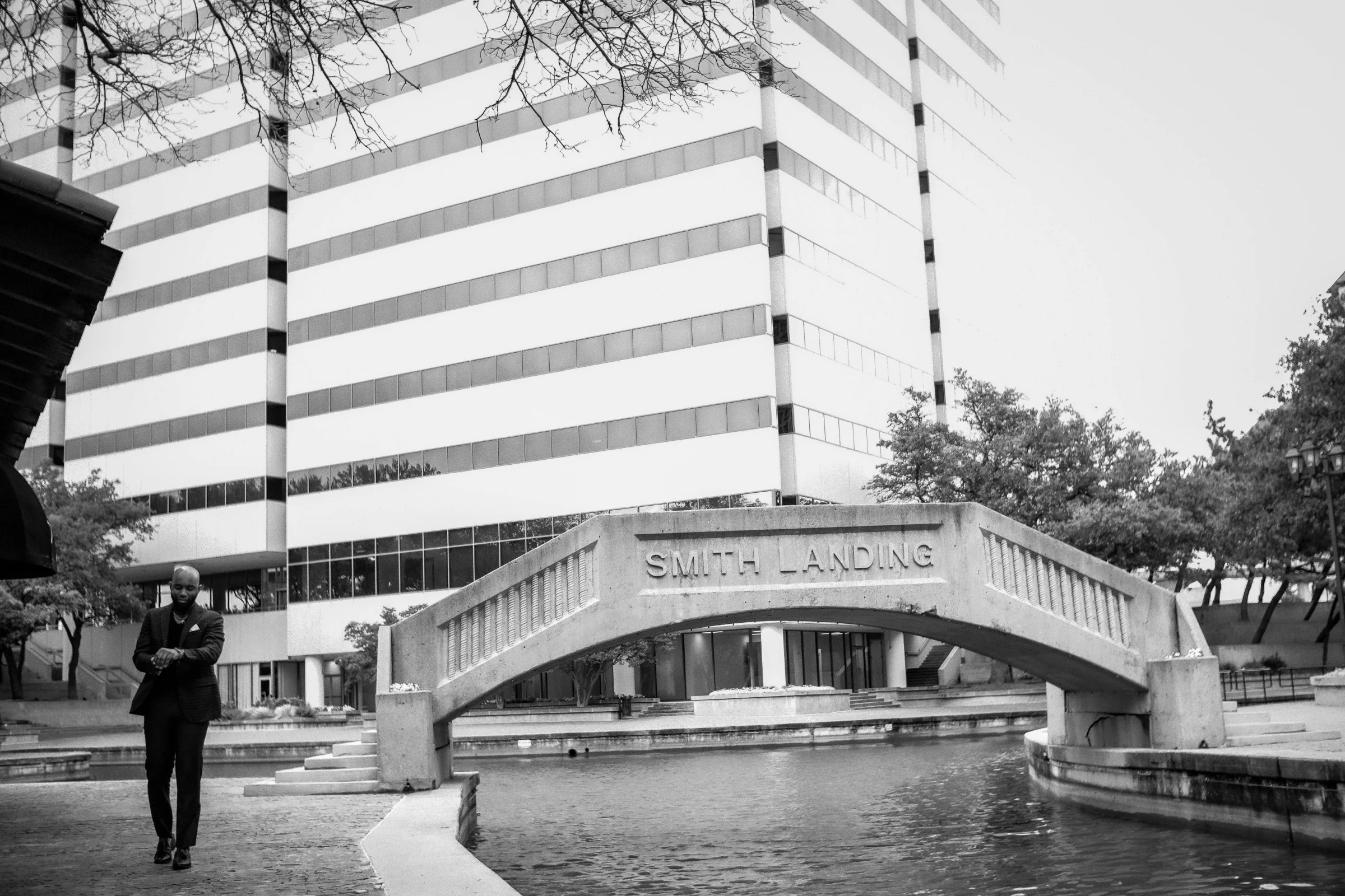 San Antonio River Walk with city skyline at sunset