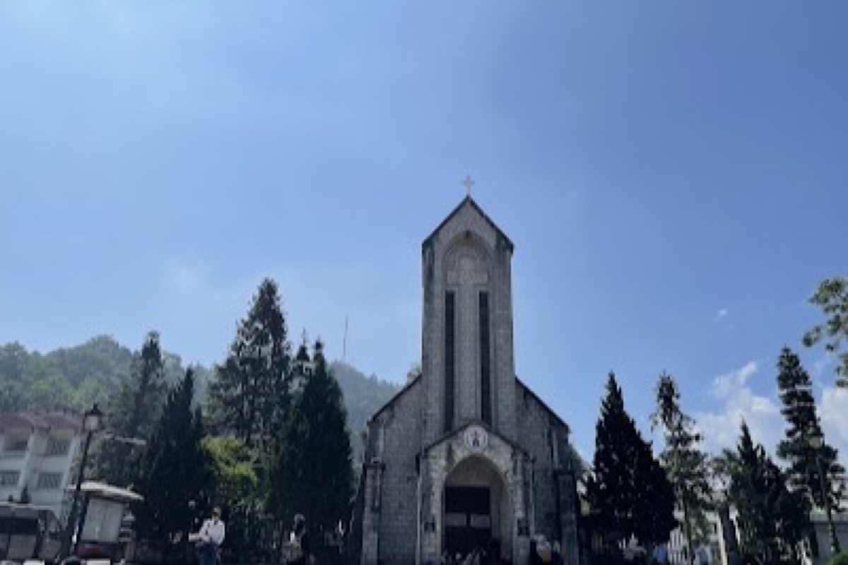 French Gothic stone church with bell tower beside the main square in Sapa town