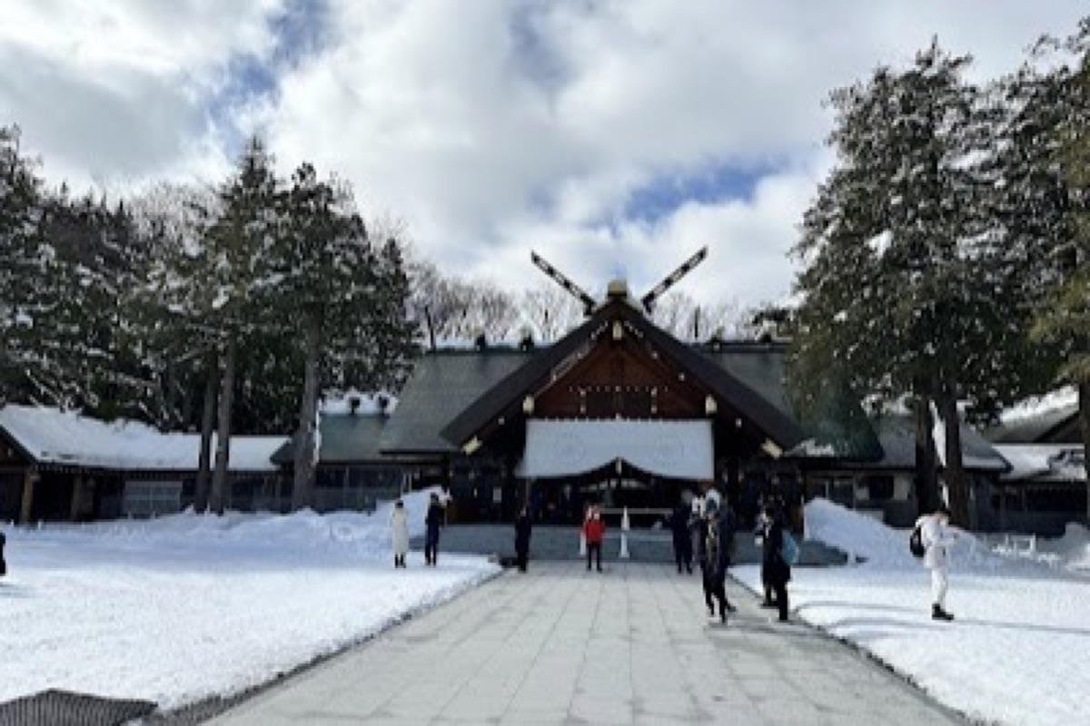 Hokkaido Shrine torii gate with snow-covered approach through Maruyama Park