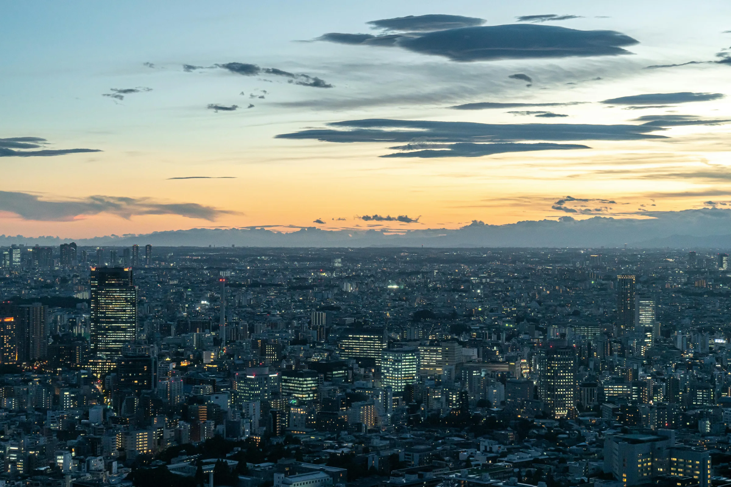 Dusk cityscape of Sendai, Japan with a lively street and skyline lights