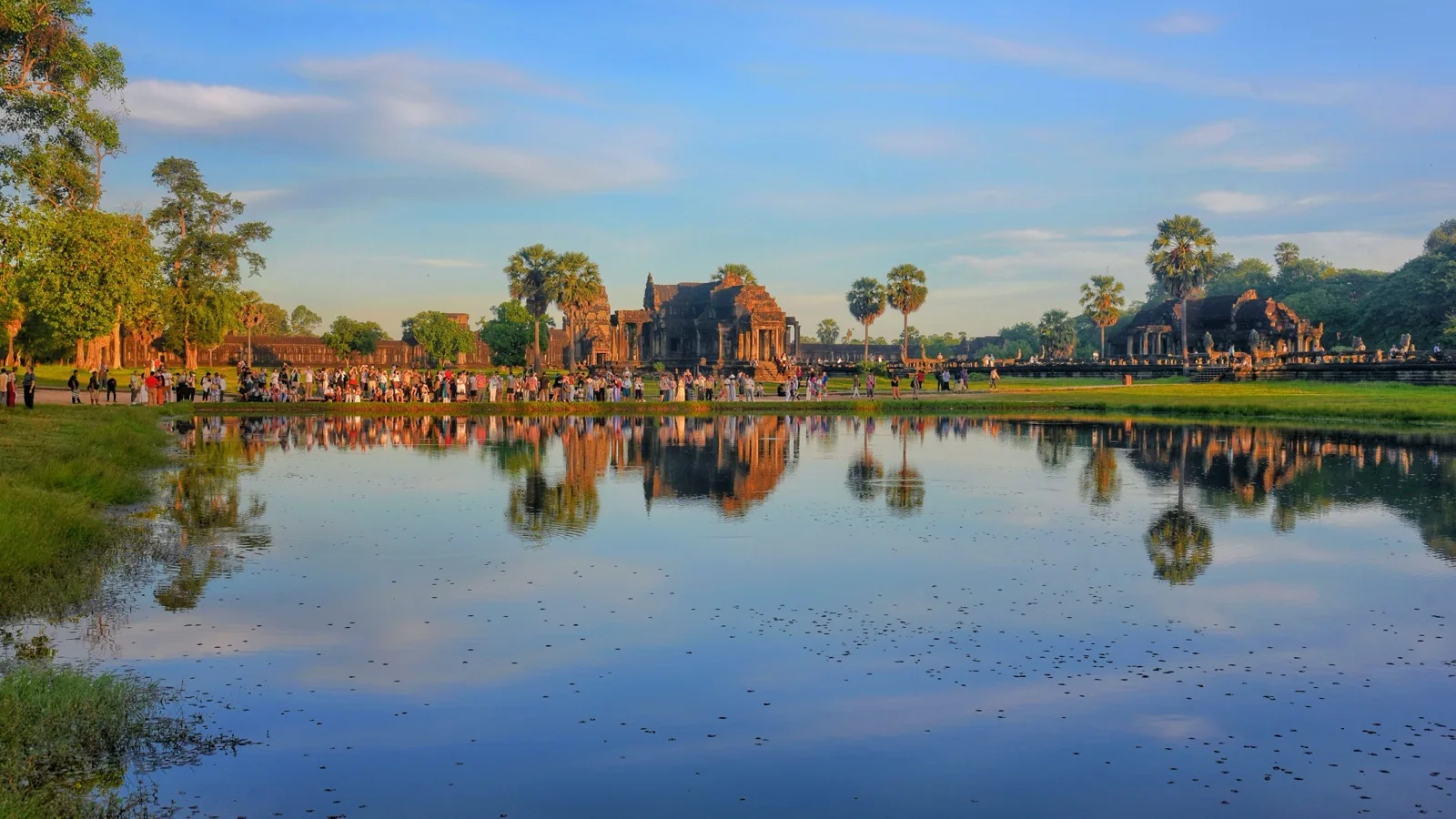 Angkor Wat's five lotus towers reflected in the western pond at sunrise
