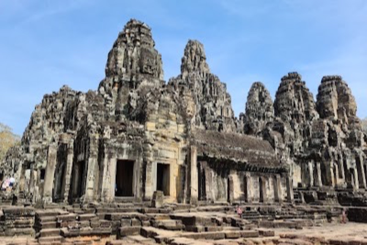 Smiling stone faces carved on the towers of Bayon Temple in Angkor Thom