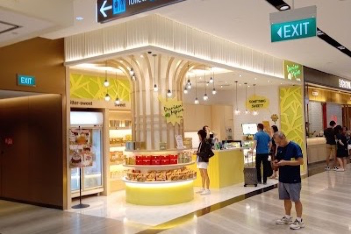 Rain Vortex indoor waterfall surrounded by forest at Jewel Changi Airport