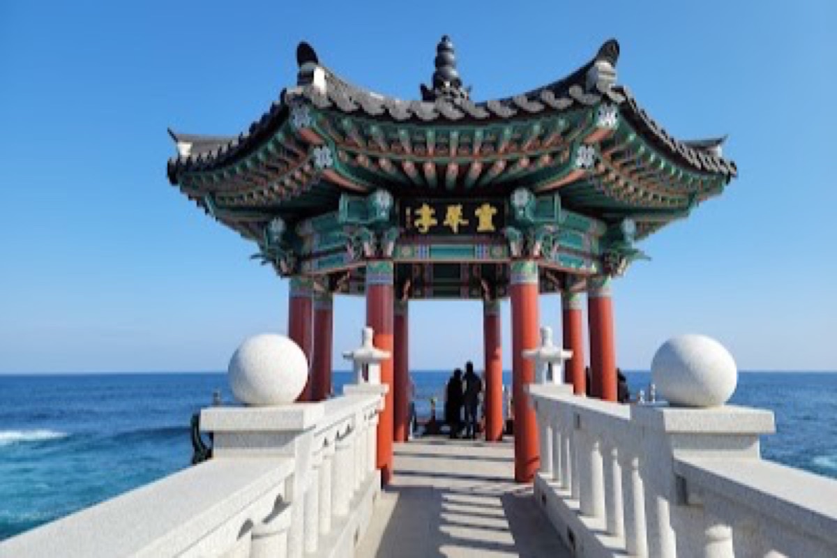 Yeonggeumjeong Pavilion sea bridge at sunrise with waves crashing below on the Sokcho coast