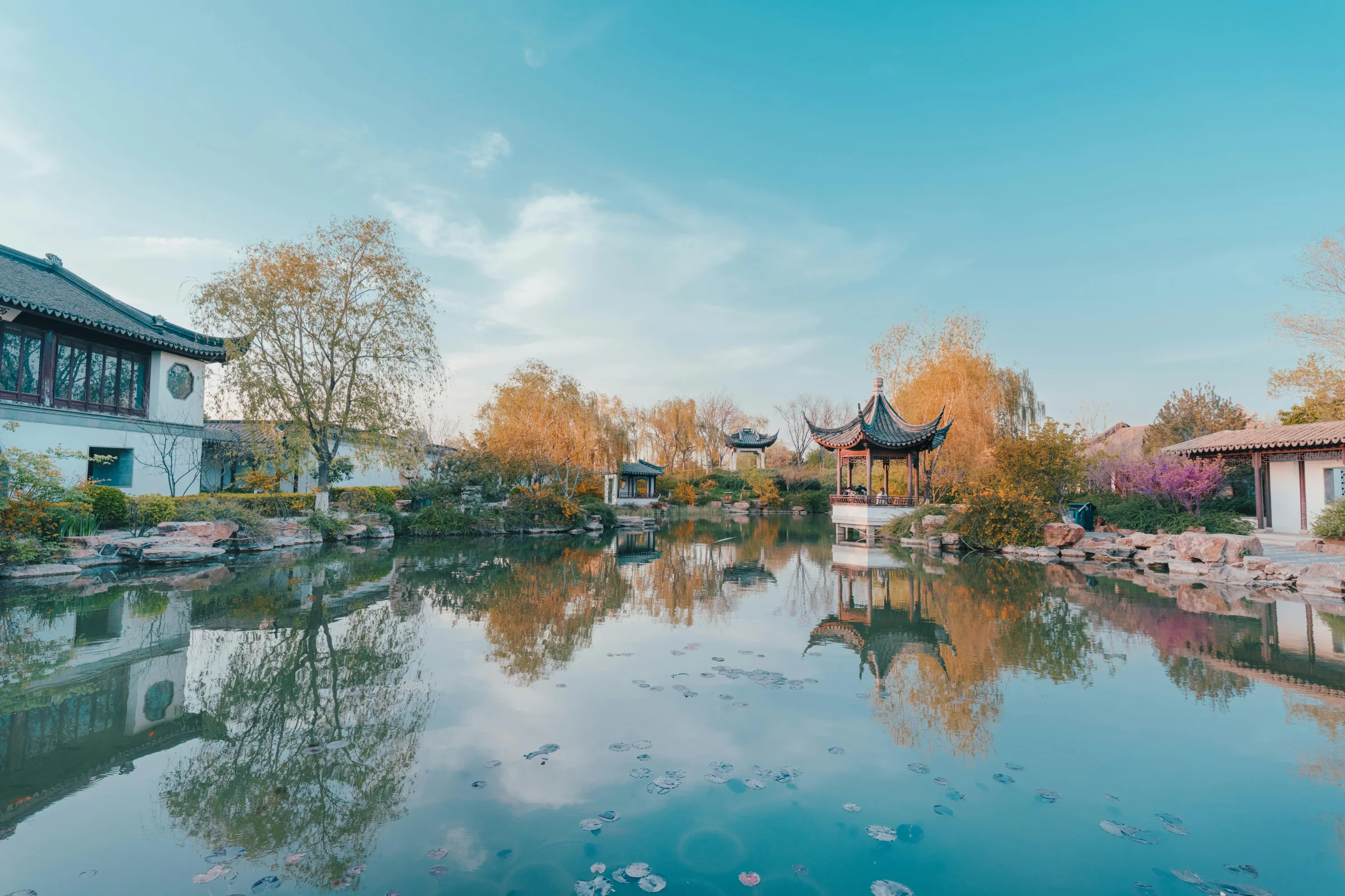 Sunset view of a Suzhou classical garden and canal with traditional architecture