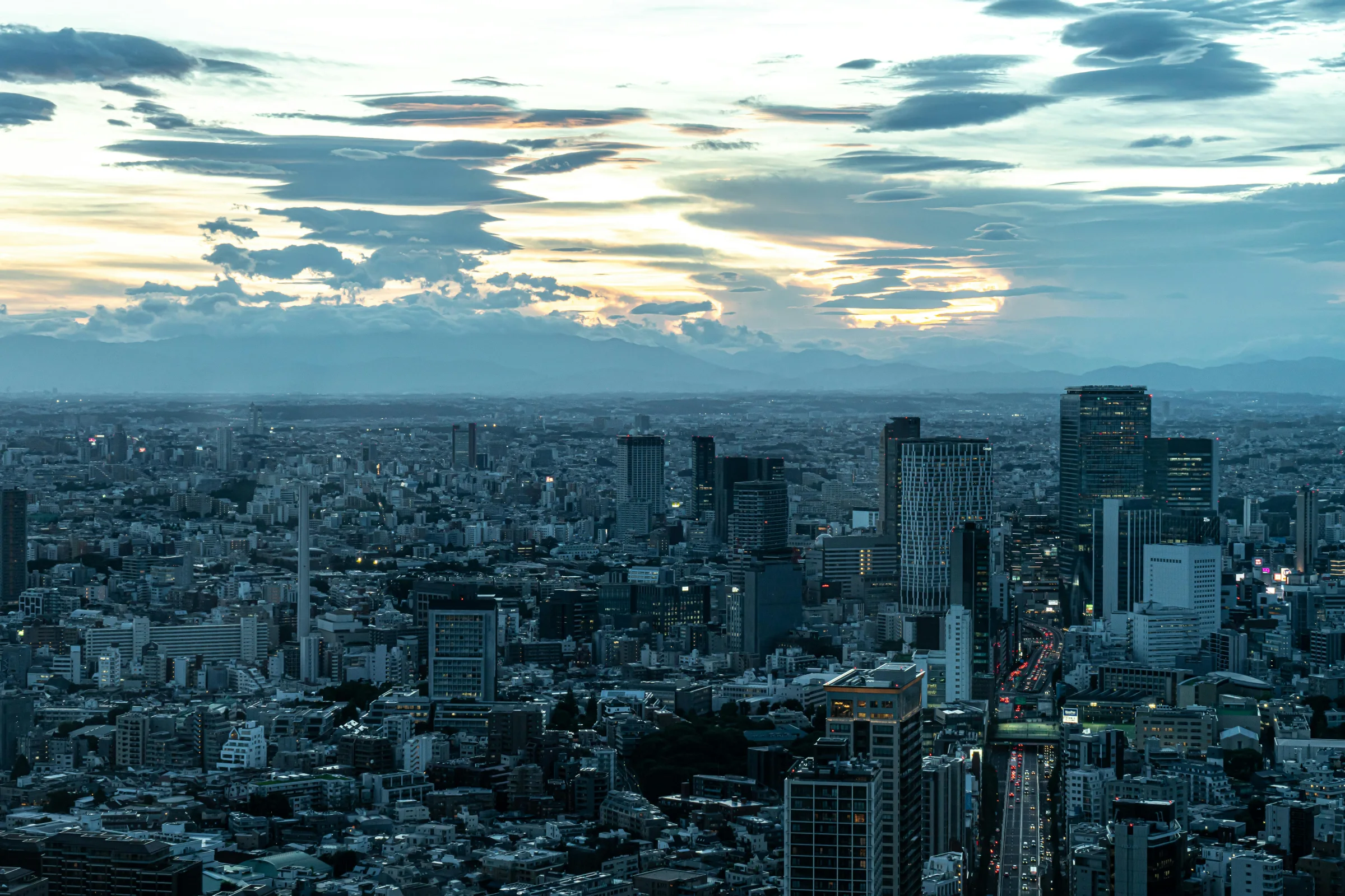 Tokyo skyline at dusk with Shibuya city lights and modern high-rises