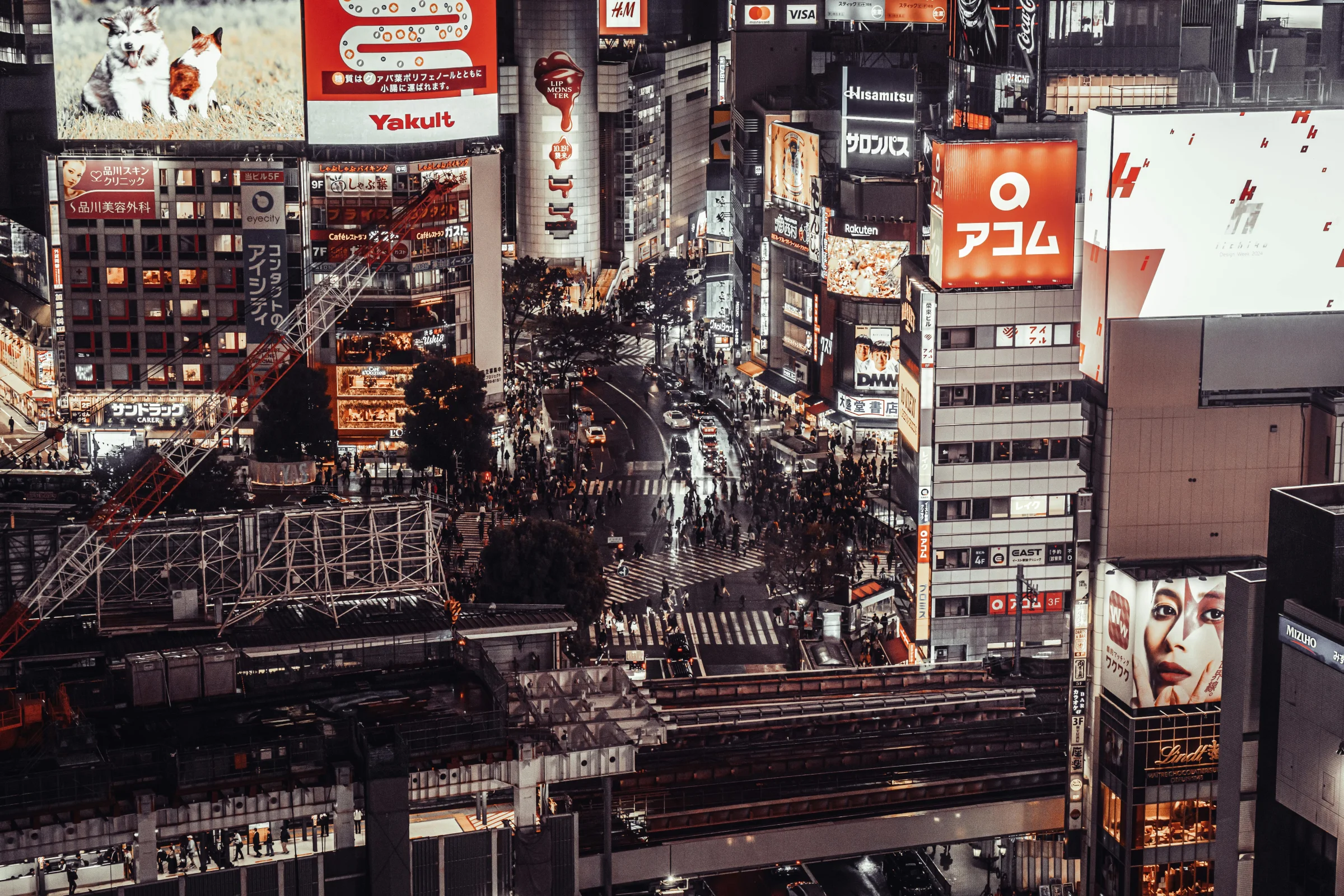 Tokyo city skyline at night with Shibuya Crossing and bright neon lights