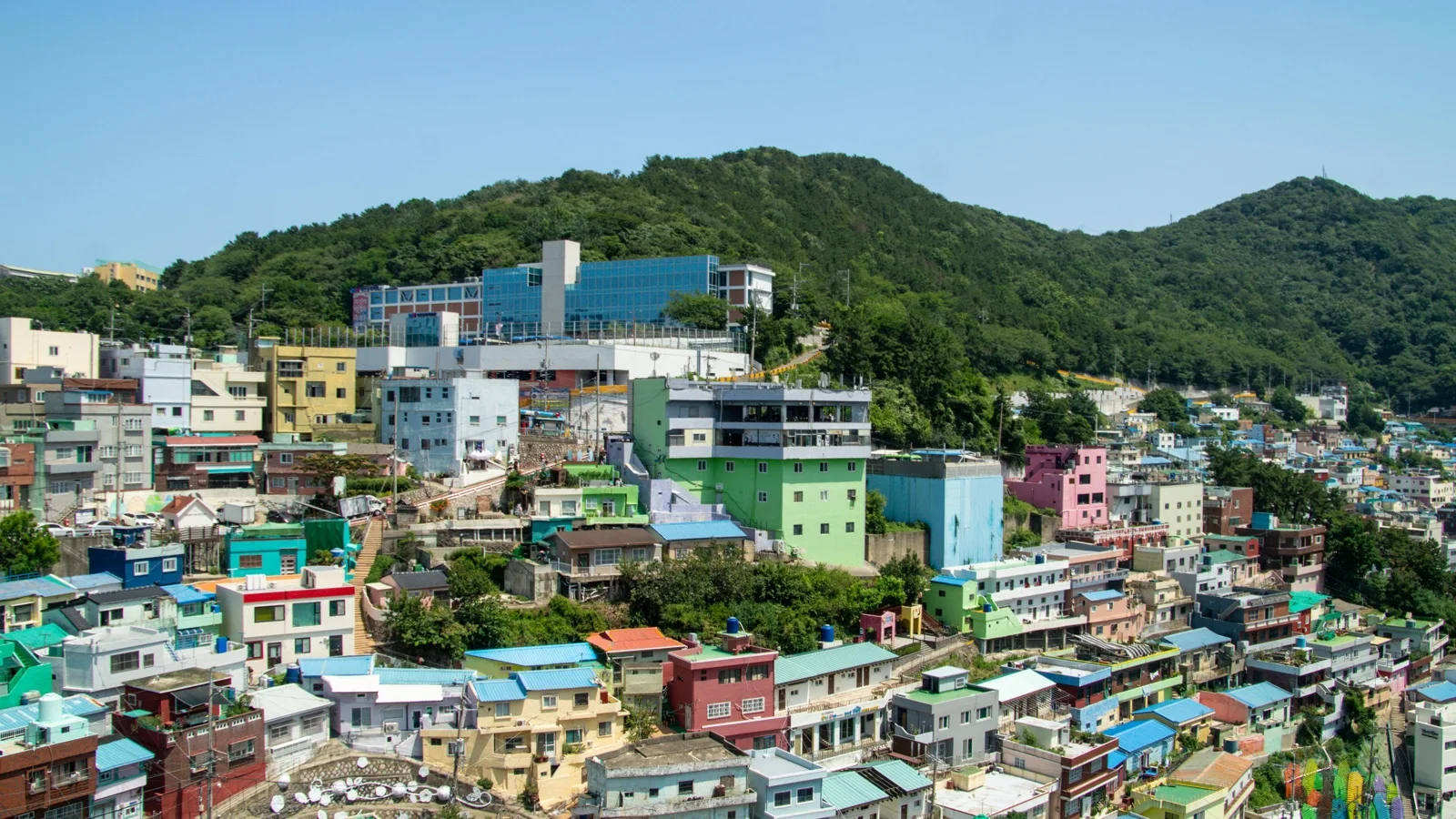 Dongpirang Mural Village colorful hillside alleys overlooking Gangguan Port with painted walls and harbor views in soft morning light