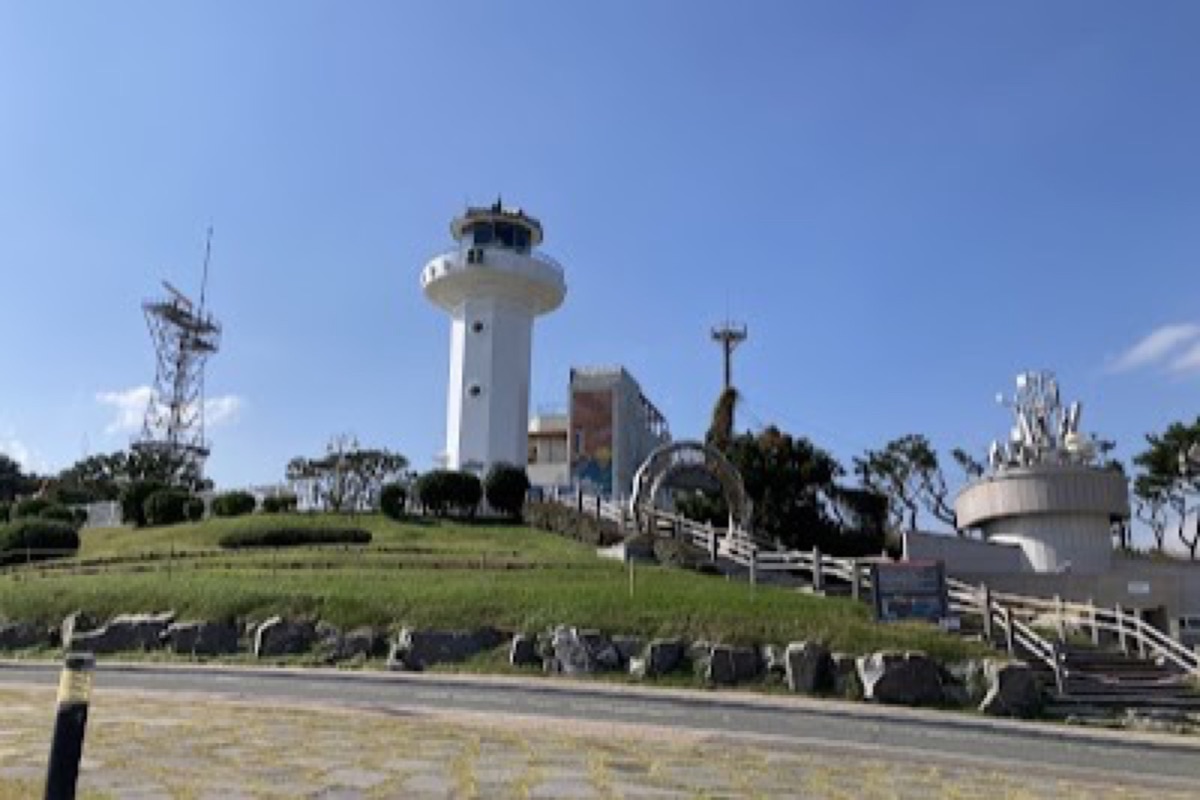 Ganjeolgot Cape lighthouse above the East Sea at sunrise with rapeseed flower fields in Ulsan