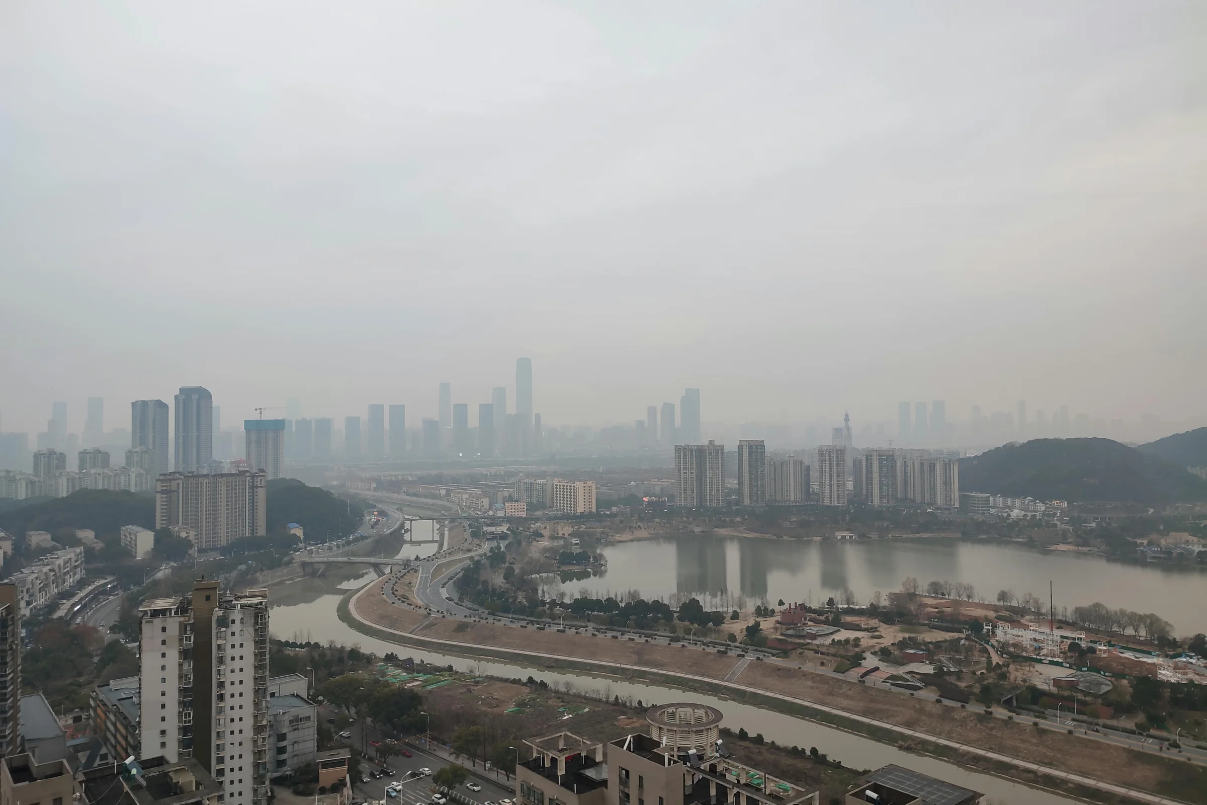 Sunset view of Weifang city skyline along a river in Shandong, China