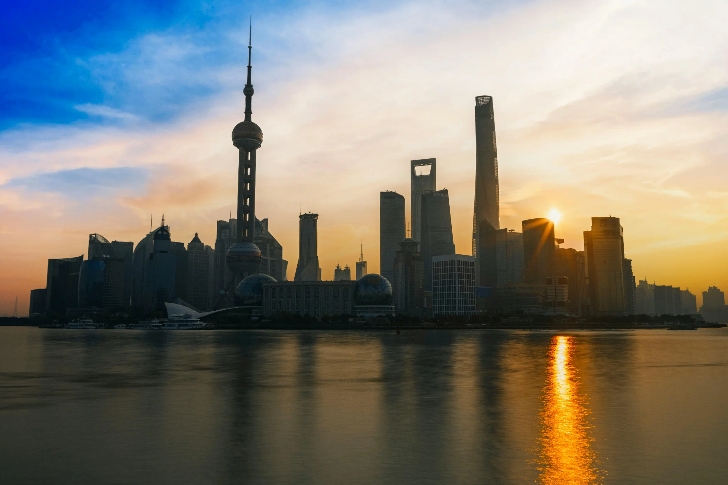 Sunset view of Wenzhou city skyline along a river in Zhejiang, China
