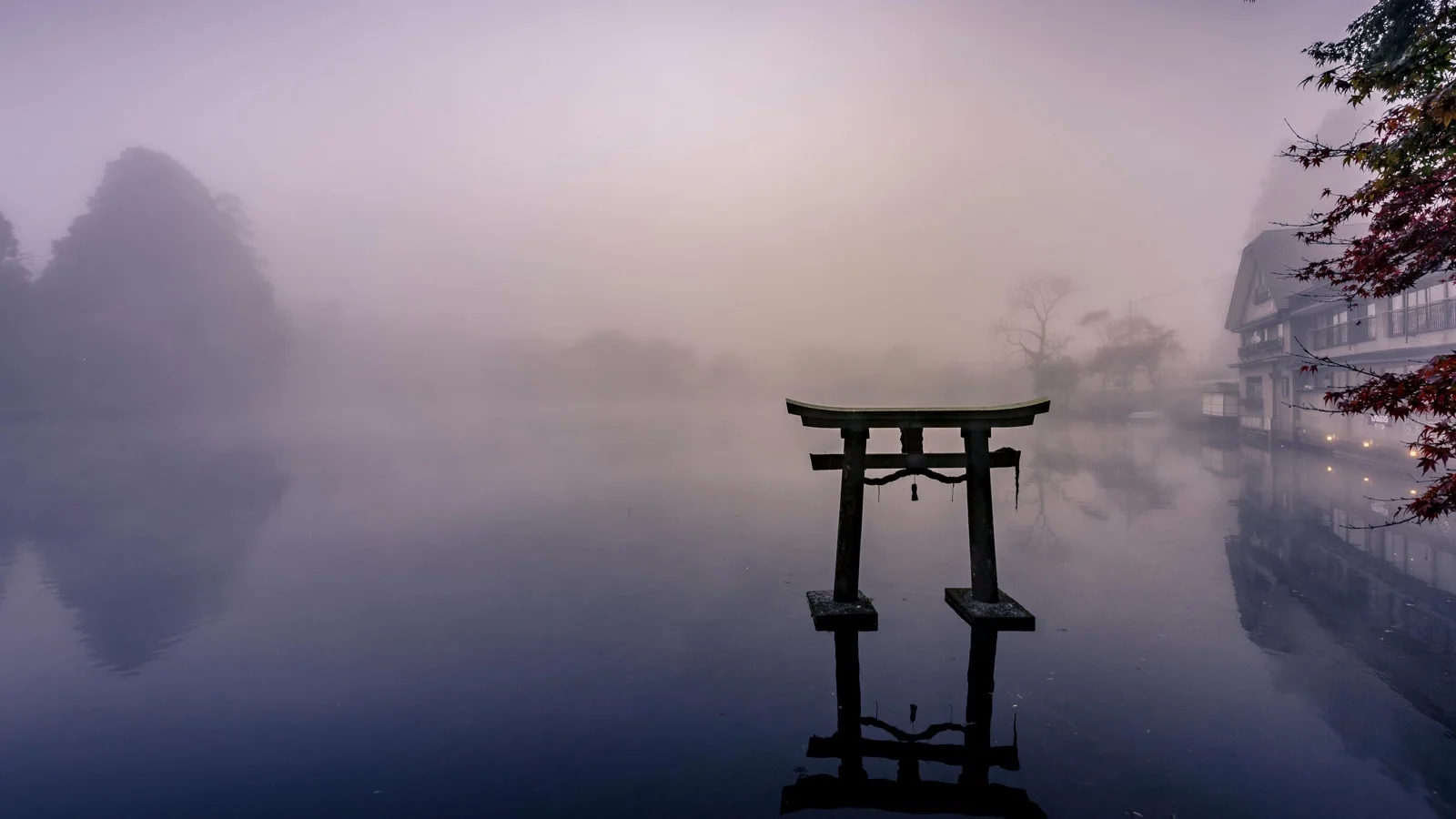 Lake Kinrinko with morning mist rising from thermal springs and Mount Yufu in the background